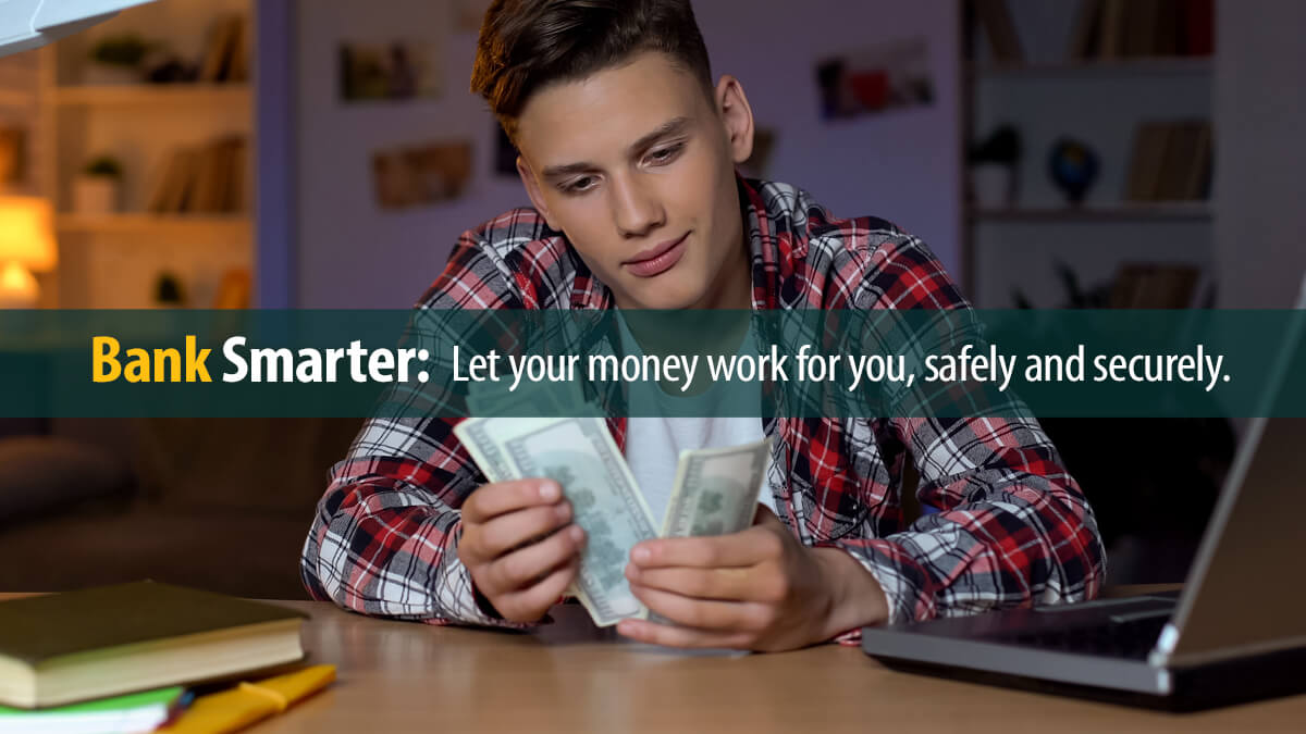 Teenager counting dollars sitting at desk.